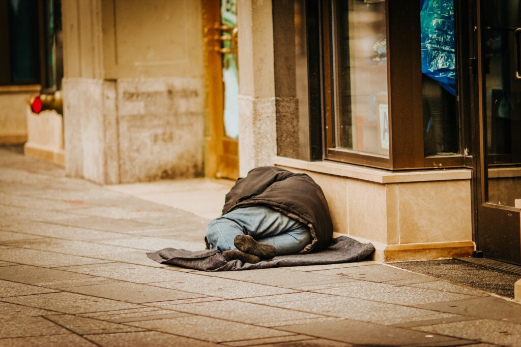 homeless man sleeping on street