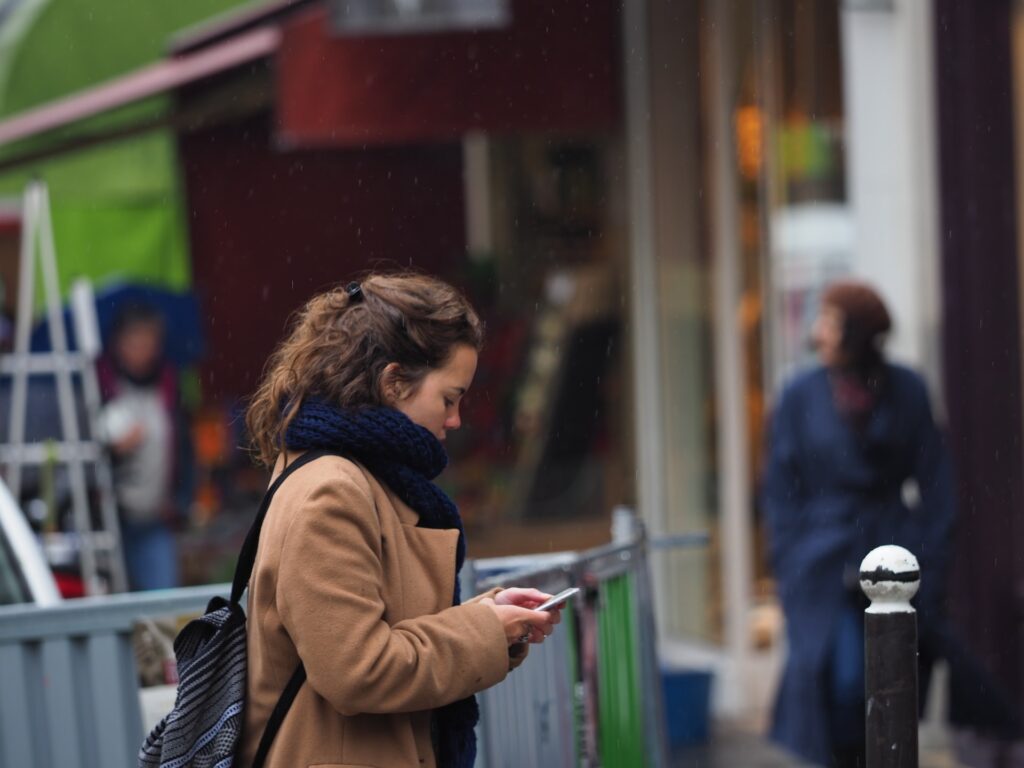 woman on street using phone