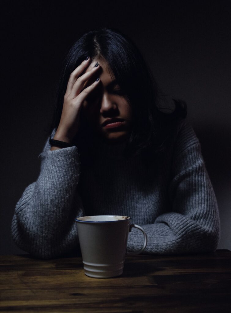 concerned woman with hot drink