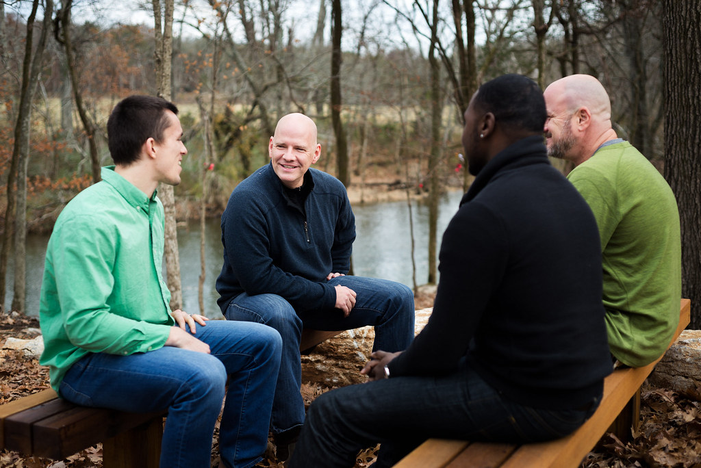 A group of four men in an outdoor therapy session.